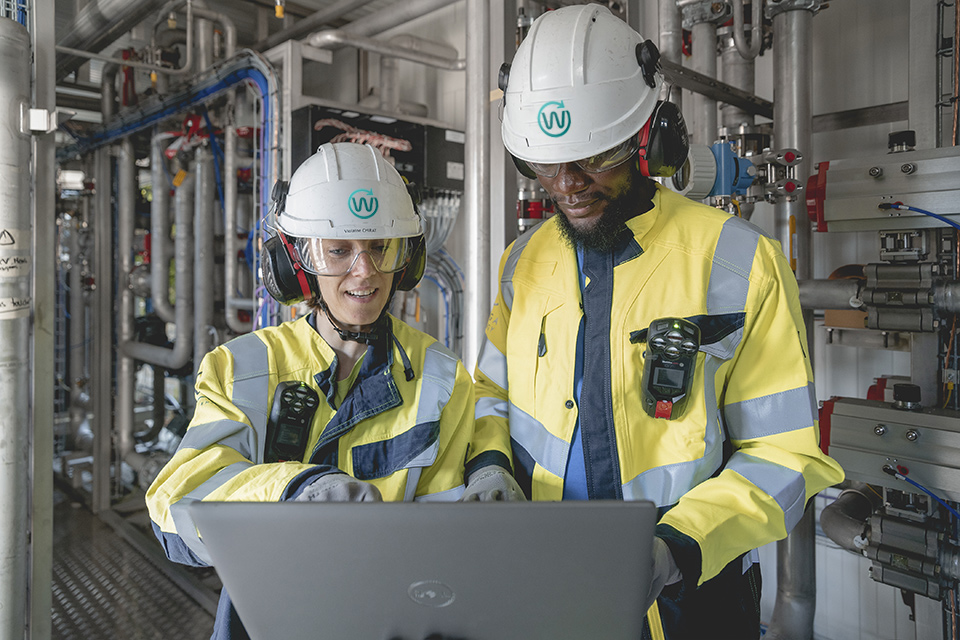 Two Waga Energy employees working in a biomethane production plant.