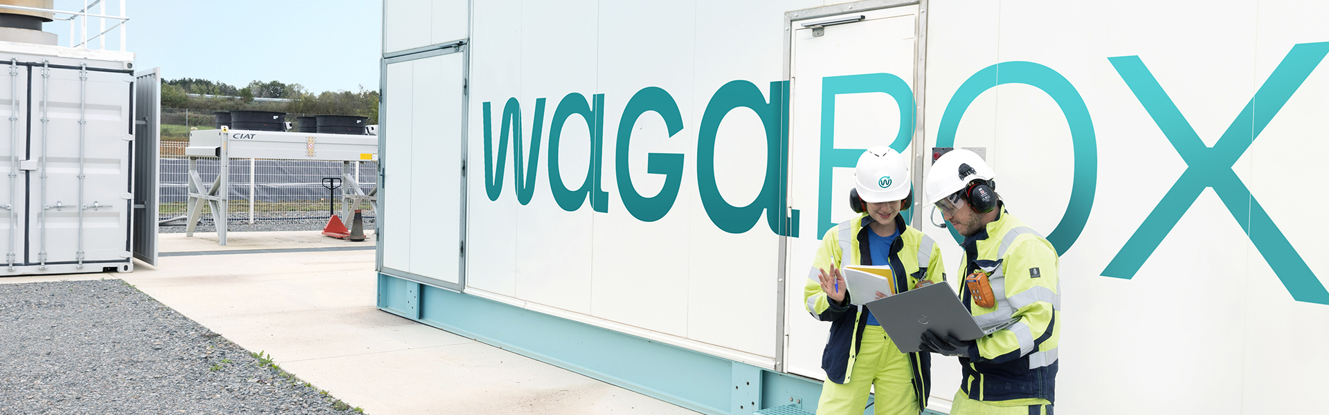 Image showing two employees working in front of a WAGABOX unit.